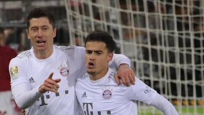 Lewandowski (L) celebrates with his team mate Philippe Coutinho. EPA