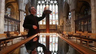 The Dean of Ripon, The Very Reverend John Dobson lights a candle of remembrance in Ripon. Reuters