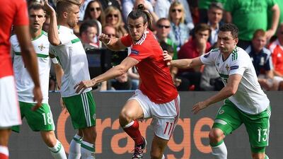 Gareth Bale of Wales and Corry Evans of Northern Ireland in action. Georgi Licovski / EPA