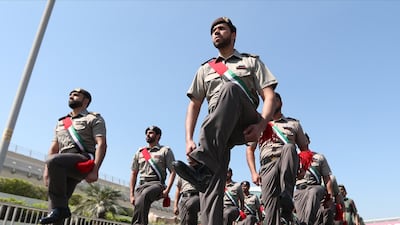 Members from Dubai Police take part in a parade in front of Dubai International Airport during UAE Flag Day in Dubai. EPA