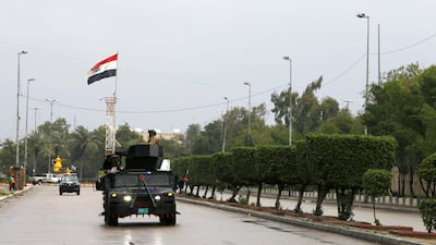 Iraqi security forces patrol a street, during a curfew imposed to prevent the spread of coronavirus disease in Baghdad in March. Iraq is having its worst annual gross domestic product growth performance in 2020 due to a number of factors including the Covid-19 pandemic, low oil prices and protests calling for a political change in the country. Reuters