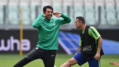 Gianluigi Buffon and Simone Pepe of Juventus stretch on Monday during their team training session for the Champions League final. Valerio Pennecino / Getty Images