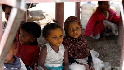 Displaced Yemeni children shield themselves from the sun at a camp for Internally Displaced Persons on the outskirts of Sana'a, Yemen, on August 7, 2021. EPA