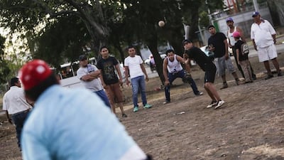 Men play baseball, or “king sport” as they call it in Nicaragua, in a neighbourhood of Managua, on January 13, 2016. Football is gaining enthusiasts in Nicaragua where baseball has been historically dominant but is now giving way to the new sport, analysts said. Inti Ocon / AFP