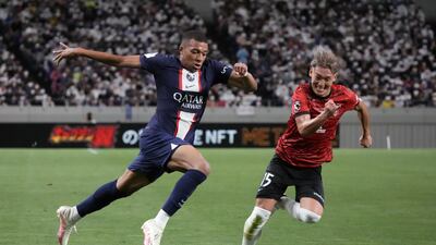 Kylian Mbappe of Paris Sait-Germain and Takahiro Akimoto of Urawa Red Diamonds. Getty