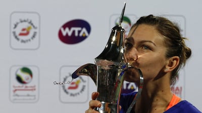 Simona Halep of Romania kisses her trophy after beating Karolina Pliskova of the Czech Republic in the final of the Dubai Duty Free Tennis Championships on February 21, 2015. Karim Sahib / AFP