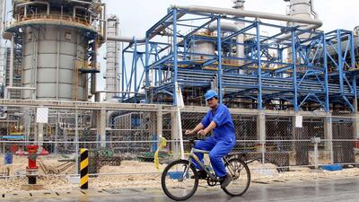 An Iranian worker rides a bicycle through the Nouri Petrochemical facilities of the South Pars gas field in the southern Iranian port of Assaluyeh. AFP