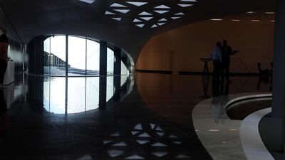 Sweeping staircases take visitors to a first-floor art gallery with screens showing a time-lapse video to explain the sustainable building’s five year construction