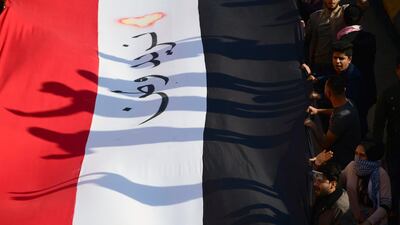 Iraqi university students chant slogans next to a banner reading "we want a homeland" in Arabic, as they take part in a demonstration in Baghdad last month. EPA
