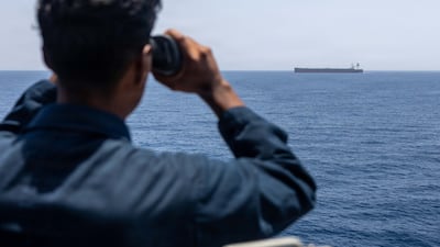 A sailor aboard the destroyer USS Rafael Peralta monitors a vessel while enforcing America's blockade against Iran. Centcom