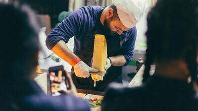 Samer Khaizaran, partner of Raclette DXB, serves at the opening of Street Food Market DXB at the Dubai International Marine Club. Courtesy Street Food Market DXB