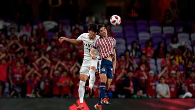 Kashima Antler's Shuto Yamamoto, left, vies for the ball with Guadalajara's Isaac Brizuela. AFP