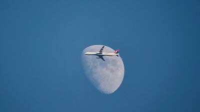 A Turkish Airlines Airbus A321-231 flies past the moon as it descends to Istanbul Airport on New Year's Day. Reuters