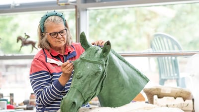 Ms Wallace works on the head of Burmese - Queen Elizabeth's favourite ceremonial steed. Photo: Miranda Meiklejohn