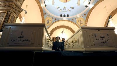 A cleric prays during the Church Mass ahead of the funeral of Coptic Christians who were killed in an attack at the Prince Tadros Church in Minya, Egypt. Reuters