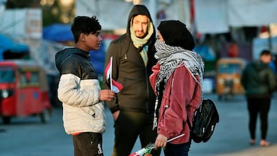 Protesters hold Valentine's Day gifts in during anti-government protests in Baghdad. AP Photo