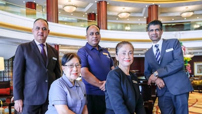Some of Beach Rotana's longest-serving staff members who have been with the hotel since the 1990s. From left, Muhammad Khan, Theresa Aungon, Nadeem Taj, Rosie Andraze and Rafi Kunju. Victor Besa / The National