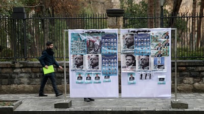 A man walks near parliamentary election campaign posters in Tehran, Iran. Reuters