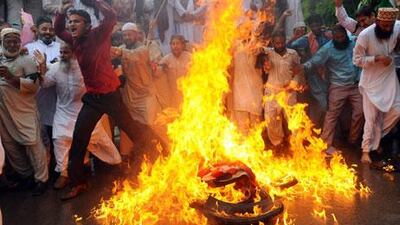 Pakistani Sunni Muslims torch a US flag during a protest against an anti-Islam movie in Lahore.