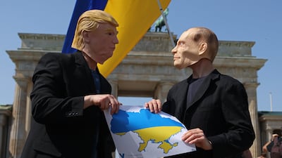 Activists dressed as US President Donald Trump and Russian President Vladimir Putin at the Brandenburg Gate in Berlin on Thursday, urging the US not to sell out Ukraine. Getty Images
