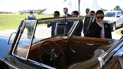 Security agents stand next to the vehicle before the start of the inauguration ceremony AFP
