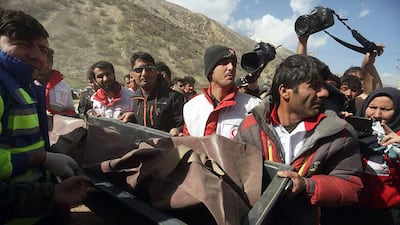 Members of the Iranian Red Crescent carry a body recovered from a wreckage of the private jet in the mountains around the city of Shahr-e Kord, Iran. Morteza Salehi / EPA
