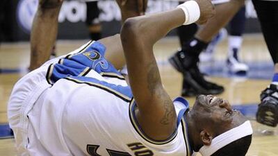 Josh Howard of the Wizards writhes in pain after injuring his left knee against the Bulls.