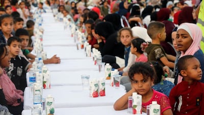 Orphans wait for iftar during Jordan's largest charity event. Reuters