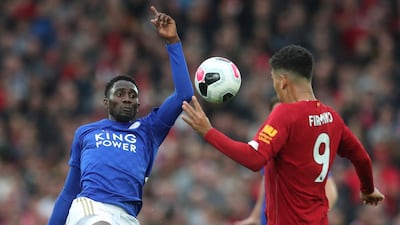 Leicester City's Wilfred Ndidi vies for the ball with Firmino. Associated Press