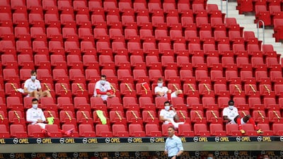 Mainz' substitutes observe social distancing in the stands. AFP