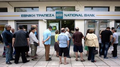 Greeks line up to withdraw cash from an ATM. Little progress in bailout talks has Greeks concerned for their savings . Alexandros Avramidis / Reuters
