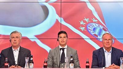 epa06082989 Bayern Munich's new player James Rodriguez (C) sits next to head coach Carlo Ancelotti (L) and CEO Heinz Rummenigge (R) as James is presented during a press conference in Munich, Germany, 12 July 2017. German Bundesliga soccer club Bayern Munich announced on 11 July 2017 James Rodriguez comes from Spain's Real Madrid on a two-year loan. EPA/LUKAS BARTH