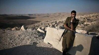 An Israeli soldier stands on a vantage point outside the Sagi Mount base, southern Israel, a few kilometres from the Israeli-Egypt border where another Israeli soldier was killed in ambush.