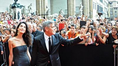 George Clooney, right, and his fiancee, Amal Alamuddin. Maurizio Degl’innocenti / EPA