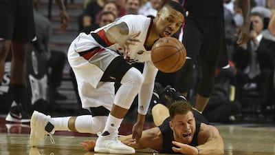 Damian Lillard of the Portland Trail Blazers and Blake Griffin of the Los Angeles Clippers go after a loose ball in the first quarter of Game Four of the Western Conference quarter-finals. Steve Dykes / Getty Images / AFP