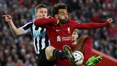 Newcastle's Matt Targett and Mohamed Salah of Liverpool battle for the ball. AFP