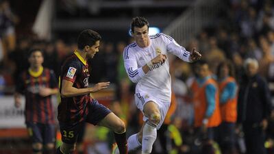 Gareth Bale, right, of Real Madrid beats Marc Bartra of Barcelona during the Copa del Rey Final between Real Madrid and Barcelona at Estadio Mestalla on April 16, 2014 in Valencia, Spain. Denis Doyle/Getty Images