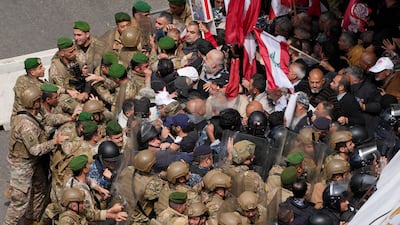 Retired army soldiers and protesters demanding better pay are pushed back by the army and riot police as they try to reach the government palace in Beirut. AP