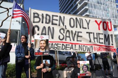 People protest calling for the immediate release of the Israeli hostages held by Hamas in Gaza, outside the venue where Mr Blinken is meeting President Herzog in Tel Aviv. EPA