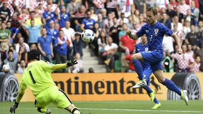 Croatia midfielder Ivan Rakitic (R) scores against Czech Republic’s goalkeeper Petr Cech (R) during the Euro 2016 Group D football match between Czech Republic and Croatia at the Geoffroy-Guichard stadium in Saint-Etienne on June 17, 2016. Jeff Pachoud / AFP