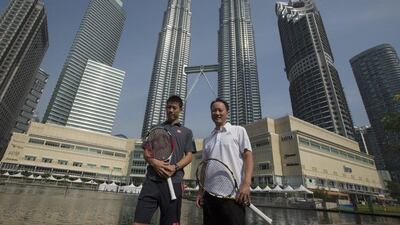 Kei Nishikori, left, poses with coach Michael Chang, right, in Kuala Lumpur on Monday ahead of the Malaysian Open. Ahmad Yusni / EPA / September 22, 2014