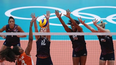 Celeste Plak of Netherlands spikes the ball against Kelly Murphy and Foluke Akinradewo of United States during the women’s bronze medal match between Netherlands and the United States on Day 15 of the Rio 2016 Olympic Games at the Maracanazinho on August 20, 2016 in Rio de Janeiro, Brazil. Buda Mendes / Getty Images
