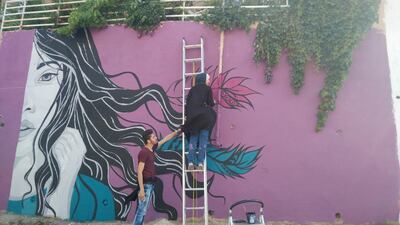 Hind Al Far works on her mural in Amman. Courtesy Baladk Project