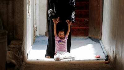 A girl is dragged by her mother to get her cholera vaccination during a house-to-house immunisation campaign in Sanaa, Yemen. Reuters