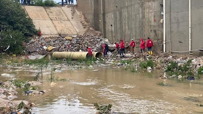 Members of the Libyan Red Crescent working on opening roads engulfed by floods in eastern Libya. AFP
