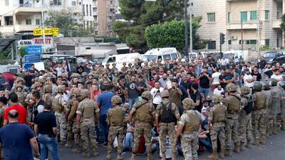 Lebanese security forces surround protesters in the southern port city of Sidon on October 18, 2019. AFP