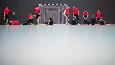 The German national handball team warms up ahead of a training session in Kamen, Germany, ahead of the forthcoming handball World Championship in France. Guido Kirchner / EPA