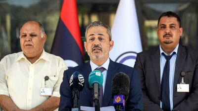 Farhat Bengdara, centre, chief of Libya's National Oil Corporation, announced the lifting of the blockade after meeting tribal elders in Benghazi. AFP