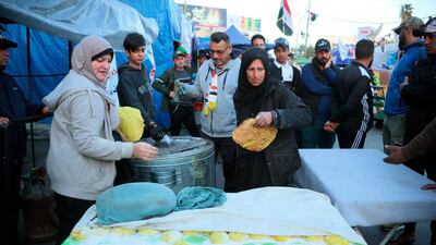 Volunteers prepare free food to anti-government protesters in Tahrir Square during ongoing protests in Baghdad, Iraq. AP Photo