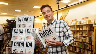 Jimmy Fallon holding his new children's book Your Baby's First Word Will Be Dada at a bookstore in New York. Myrna Suarez via AP